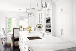 Bright horizontal image of classic white kitchen, with marble island that had move in move out cleaning in Plano, TX