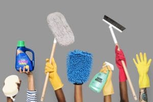 Hands holding cleaning tools and solutions for deep cleaning services in Plano, TX