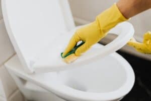 A person holding a sponge doing deep cleaning services in in Plano, TX