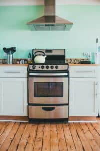 stove in a kitchen with a green wall that had deep cleaning services Dallas Sunrise Maids Plano, TX
