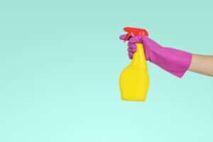 hand wearing pink glove with spray bottle for deep cleaning services Dallas Sunrise Maids Plano, TX