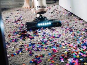 Vacuum carpet of glitter confetti that need deep cleaning services Dallas Sunrise Maids Plano, TX