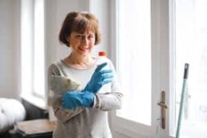 woman with cleaning products for deep cleaning services Dallas Sunrise Maids Plano, TX