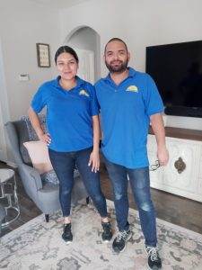 Two Dallas Sunrise Maids pausing during a house cleaning service visit in Plano TX, standing in a bedroom