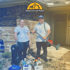 Two house cleaners outside of a home holding their cleaning equipment