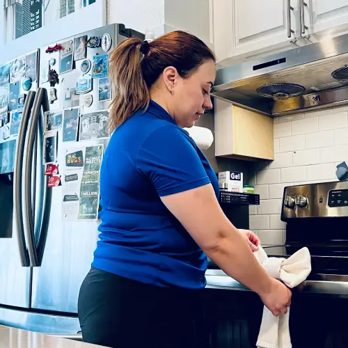 Dallas Sunrise Maids staff providing expert apartment cleaning services in a kitchen