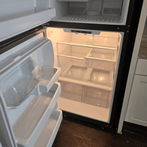 Deep cleaning inside refrigerator during move-in cleaning services by Dallas Sunrise Maids in Plano