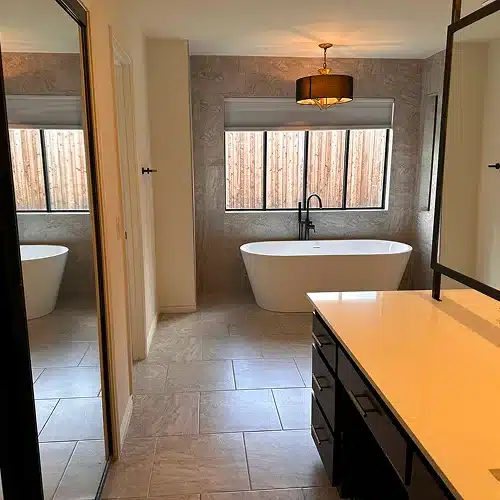 Modern gray kitchen with white island cleaned to perfection, demonstrating move out cleaning vs deep cleaning by Dallas Sunrise Maids in Plano, TX