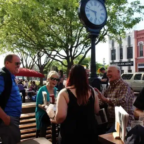 Plano residents socializing downtown reflecting community focus of Dallas Sunrise Maids in Plano