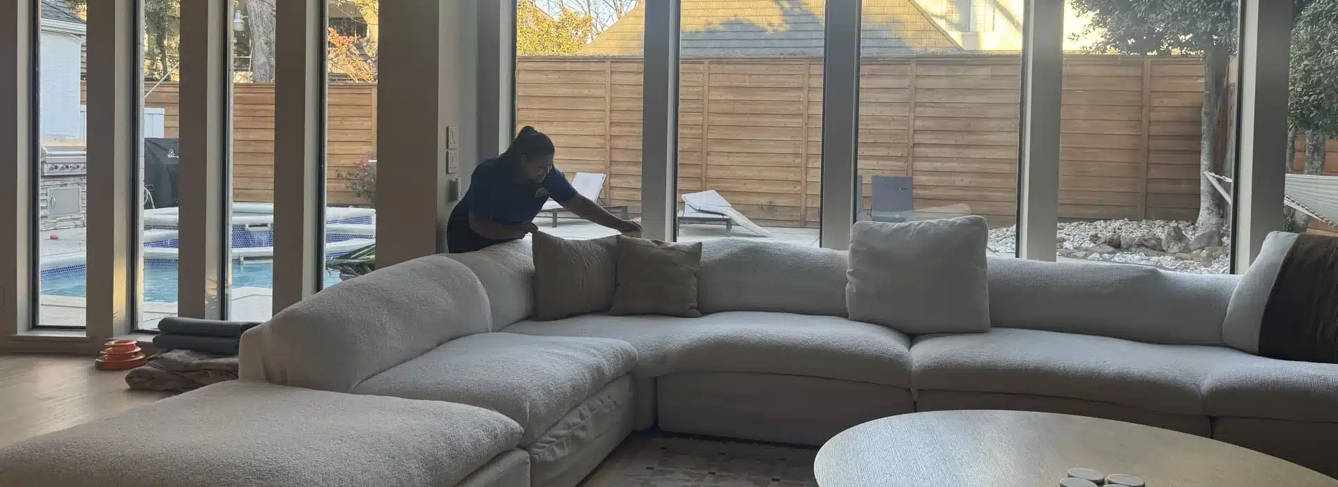 Plano house cleaning company professional tidying living room by Dallas Sunrise Maids in Plano