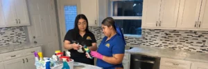 Two Dallas Sunrise Maids cleaners reviewing cleaning products during a recurring house cleaning service by Dallas Sunrise Maids in Plano, TX
