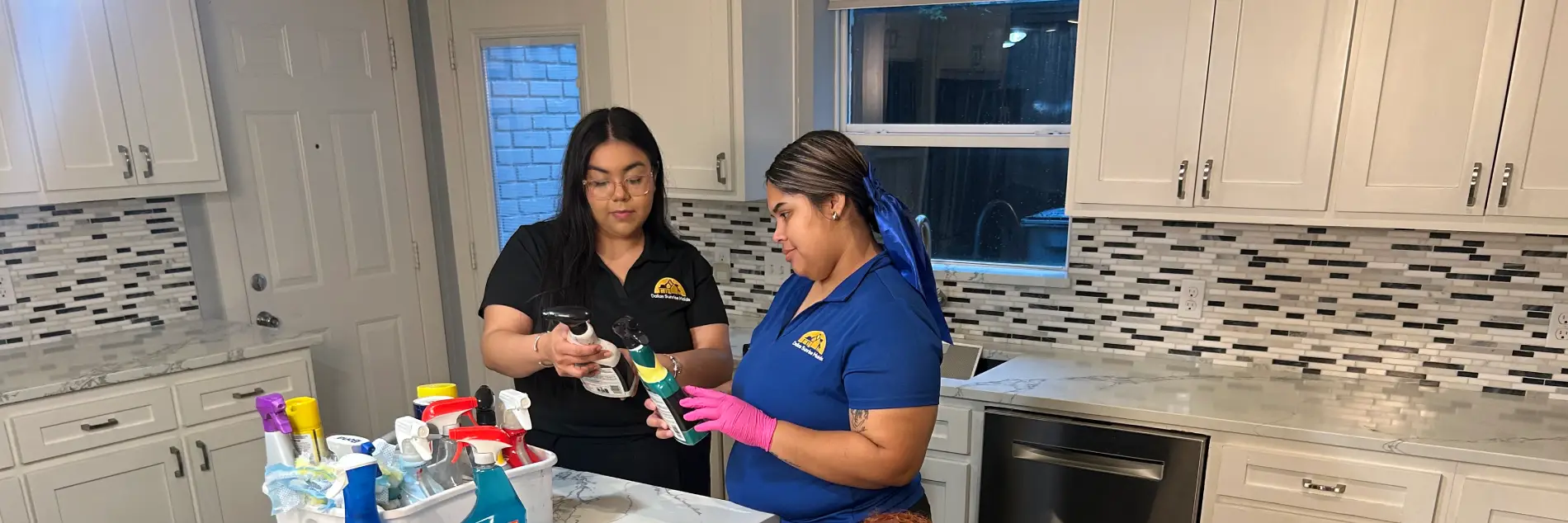 Two Dallas Sunrise Maids cleaners reviewing cleaning products during a recurring house cleaning service by Dallas Sunrise Maids in Plano, TX